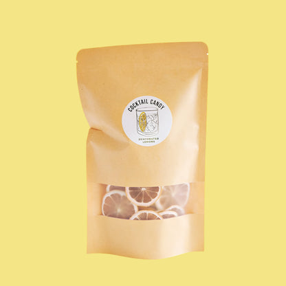 Beige packaging of cocktail candy with a visible brand label on a yellow background