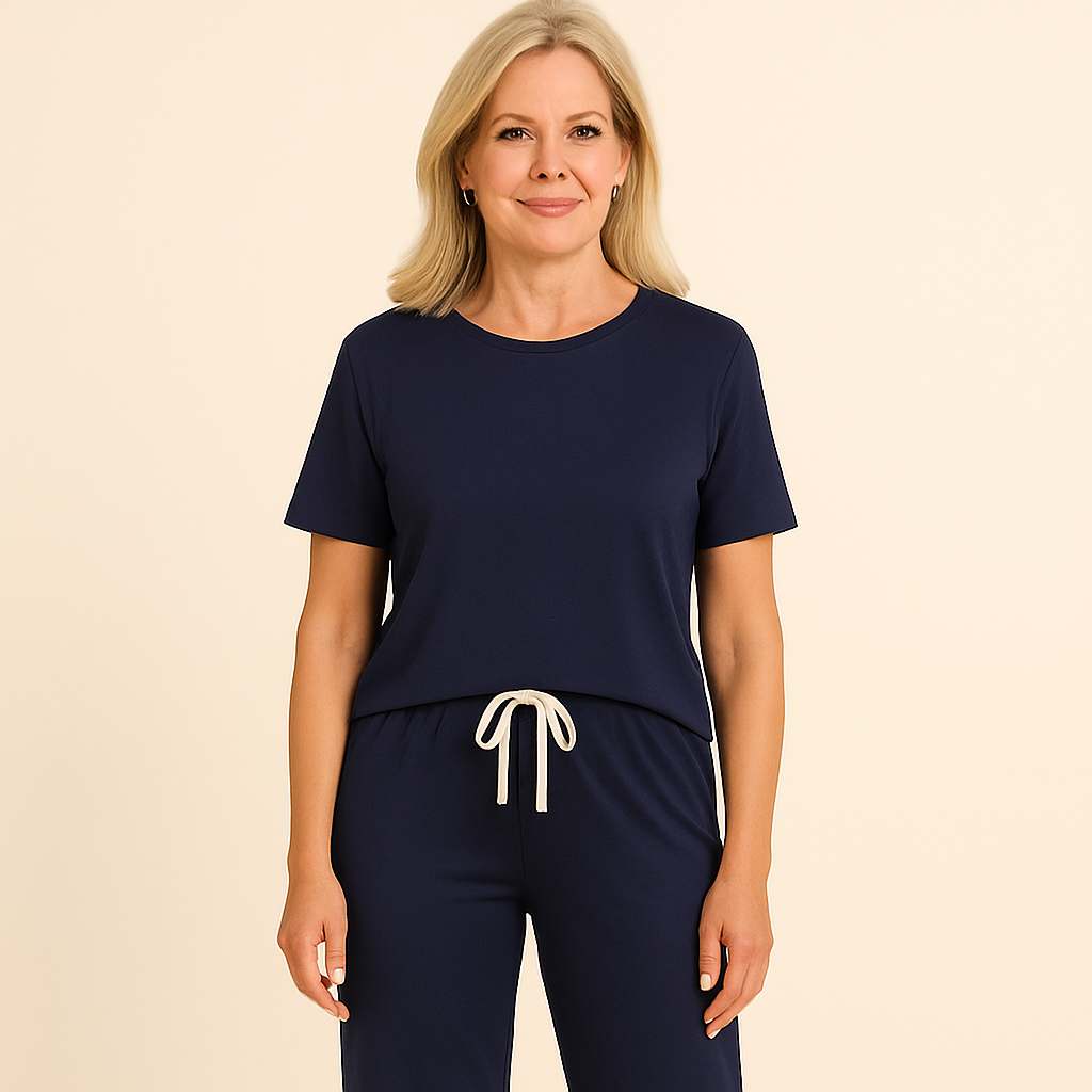 Woman wearing a navy blue outfit with white drawstring on a beige background