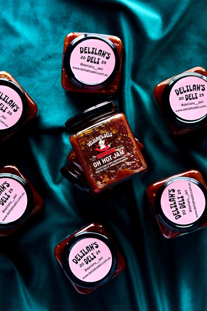 Jars of Delilan's On Hot Jam on a teal fabric background