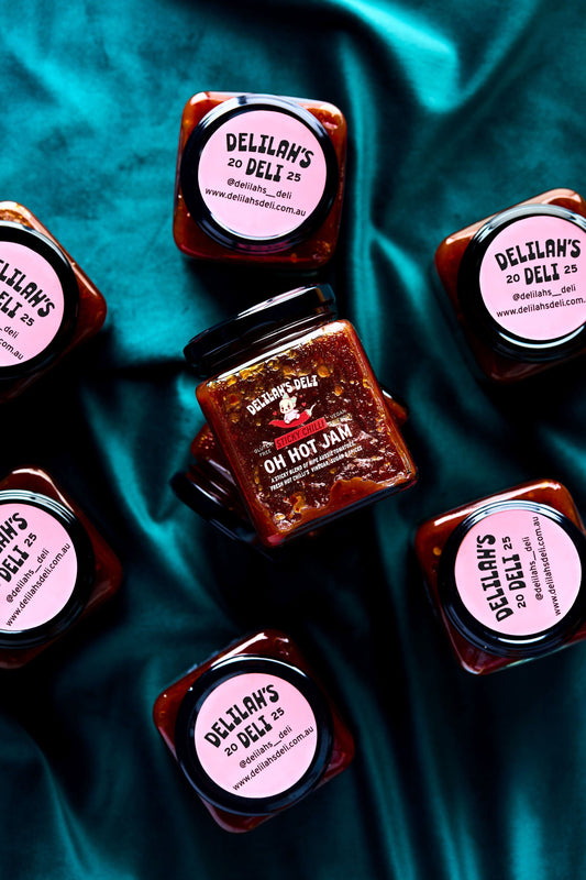 Jars of Delilan's On Hot Jam on a teal fabric background