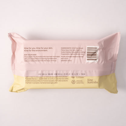 Pink and yellow package of Kine Australia baby flushable wipes on a white background. Baby Wipes Safe for Kids. Biodegradable Travel wet wipes .