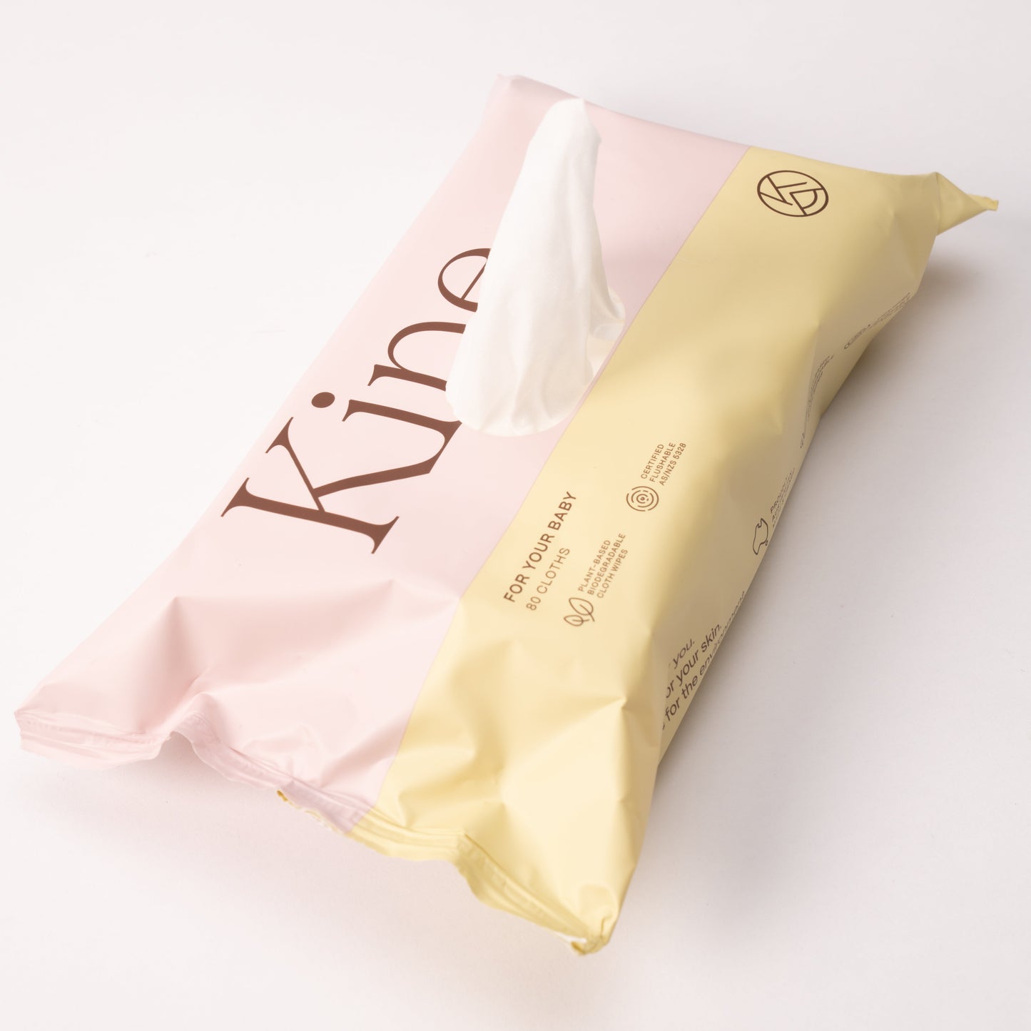 Pink and yellow baby wet wipes with 'Kine' branding on a white background.  Baby wipes flushable, gentle baby wipes, flushable compostable wipes, flushable wipes Australia. Hypoallergenic wipes.