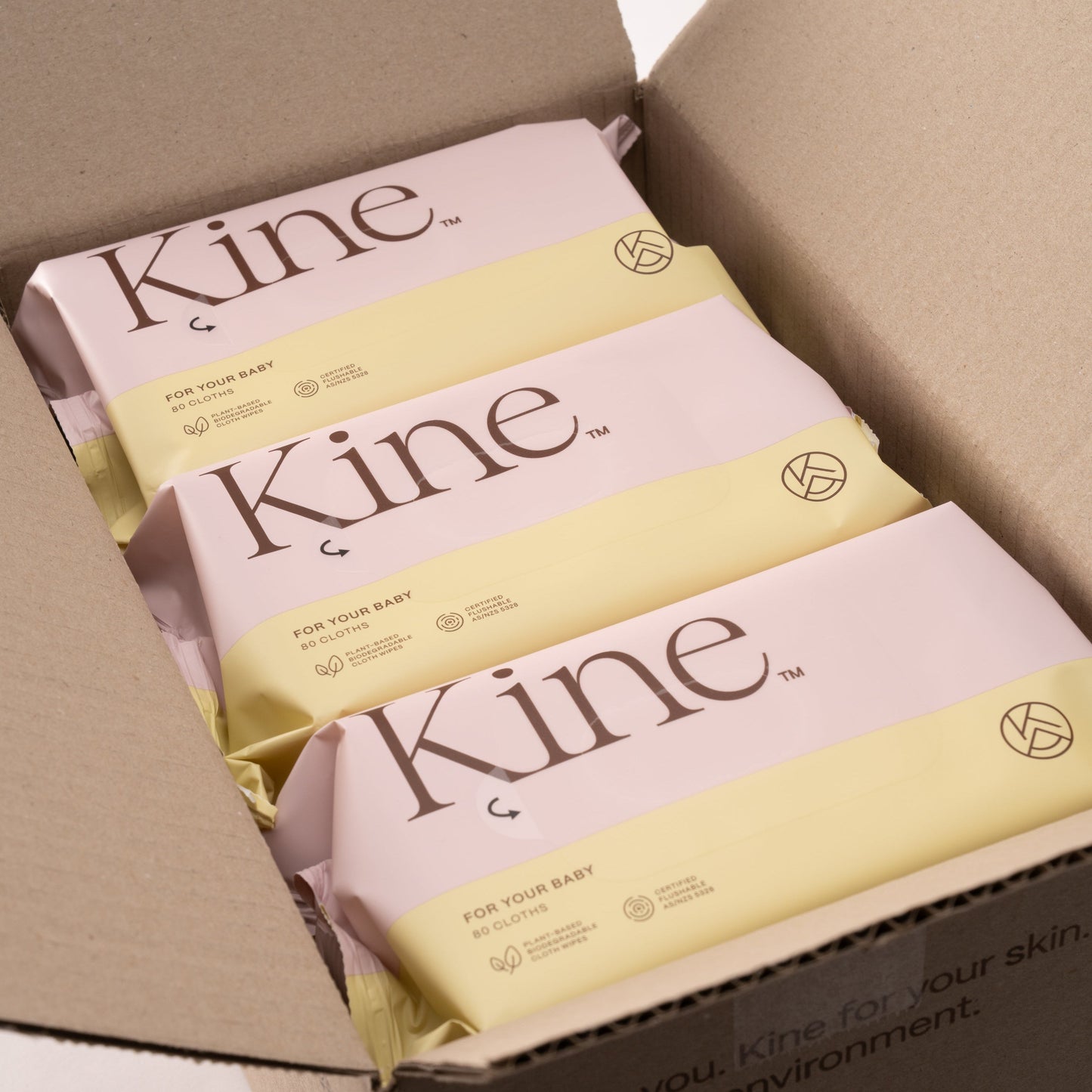 Kine products in a cardboard box on a white background. Hypoallergenic baby wet wipes Australia, plant-based wipes, flushable wipes, biodegradable flushable wipes, eco-friendly wet wipes. 100% plant-based wipes