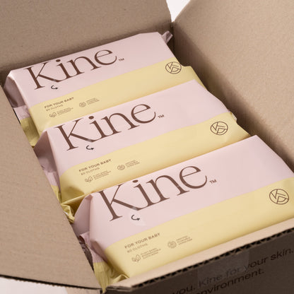 Kine products in a cardboard box on a white background. Hypoallergenic baby wet wipes Australia, plant-based wipes, flushable wipes, biodegradable flushable wipes, eco-friendly wet wipes. 100% plant-based wipes