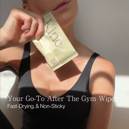 Person holding a new flushable wipe labeled 'Kine' for after gym use. Certified flushable AS/NZS 5328. Flushable compostable wipes. Travel wet wipes