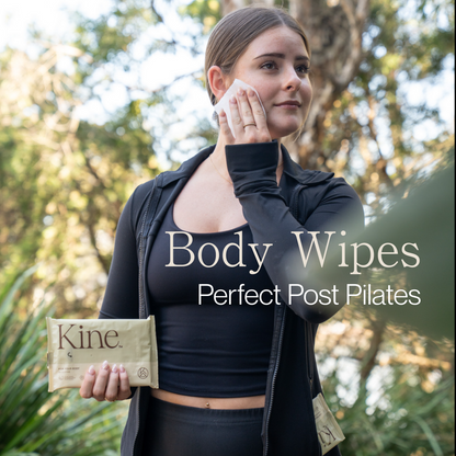 Woman using body wipes outdoors with text 'Body Flushable Wipes Perfect Post Pilates' and 'Kine' branding. Hypoallergenic wipes Australia, plant-based wipes.