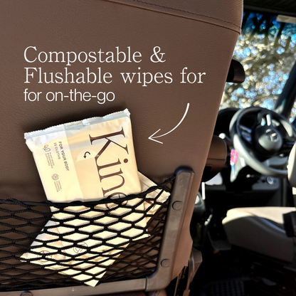 Kine compostable and flushable wipes package in a car's netted storage area.Travel wet wipes, travel wipes flushable, on-the-go wipes, certified flushable AS/NZS 5328. Travel wet wipes