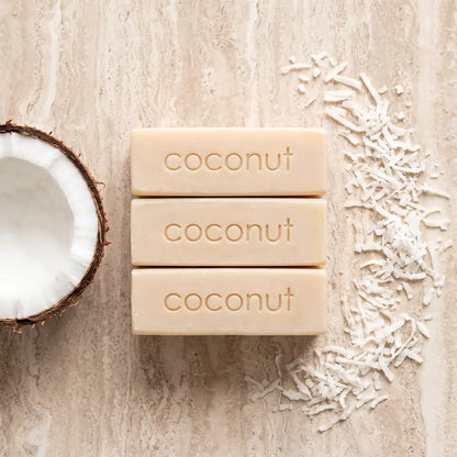 Luxury flatlay of Tasic Pure Oils Shredded Coconut Soap bars styled with cracked coconut and shredded coconut